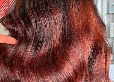 Vibrant copper hairstyle at Hair by Keri Muir, Larbert, Scotland, GB featuring a soft, wavy finish.