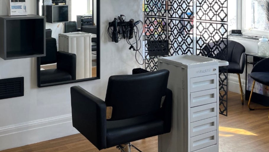 Modern salon chair and decor at Hair by Keri Muir, Larbert, Scotland, GB, showcasing elegance and comfort.