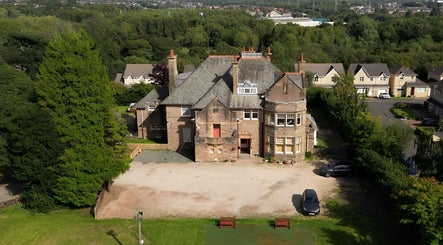 Aerial view of Hair by Keri Muir, located in a picturesque estate in Larbert, Scotland, GB, surrounded by greenery.