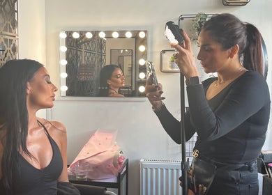 Stylist working on client's hair at Hair by Keri Muir, Larbert, Scotland, GB. Mirror reflections enhance modern look.