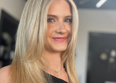 Smiling woman with sleek blonde hair at Hair by Keri Muir in Larbert, Scotland, GB.