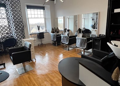 Elegant interior of Hair by Keri Muir in Larbert, Scotland, GB, featuring modern styling stations and sleek decor.