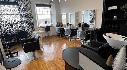 Elegant interior of Hair by Keri Muir in Larbert, Scotland, GB, featuring modern styling stations and sleek decor.