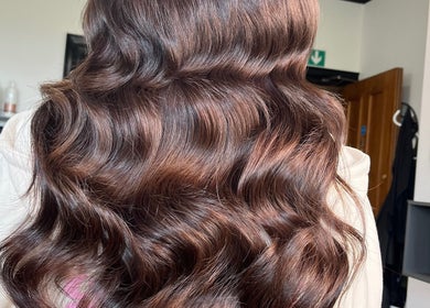 Beautiful wavy hair styled by Hair by Keri Muir in Larbert, Scotland, GB showcasing rich color and shine.