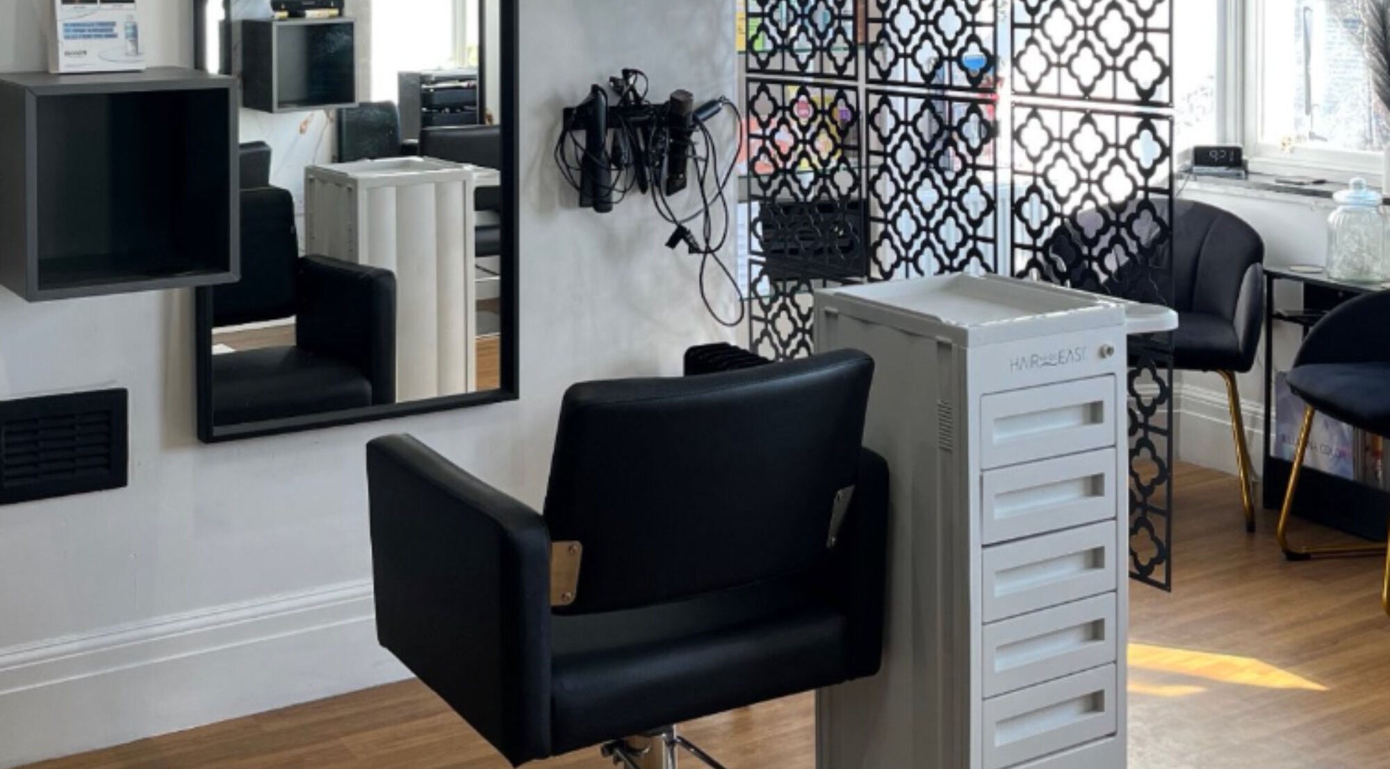 Modern salon interior at Hair by Keri Muir in Larbert, Scotland, GB, featuring stylish decor and comfortable seating.