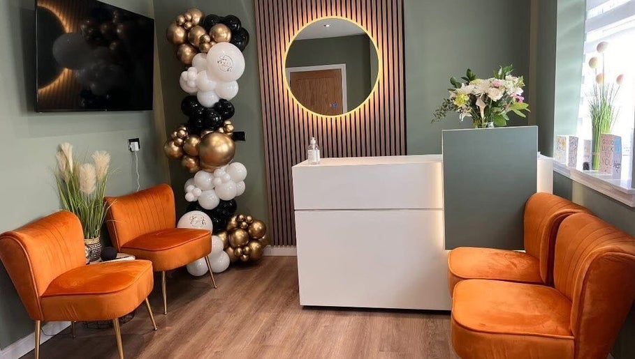 Elegant reception area at Natalie Mcintyre Aesthetics, Bishopbriggs, Scotland, GB with seating and decor.