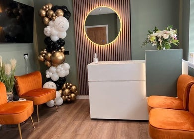 Elegant reception area at Natalie Mcintyre Aesthetics, Bishopbriggs, Scotland, GB with seating and decor.
