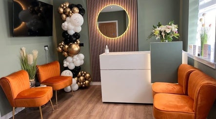 Elegant reception area at Natalie Mcintyre Aesthetics, Bishopbriggs, Scotland, GB with seating and decor.