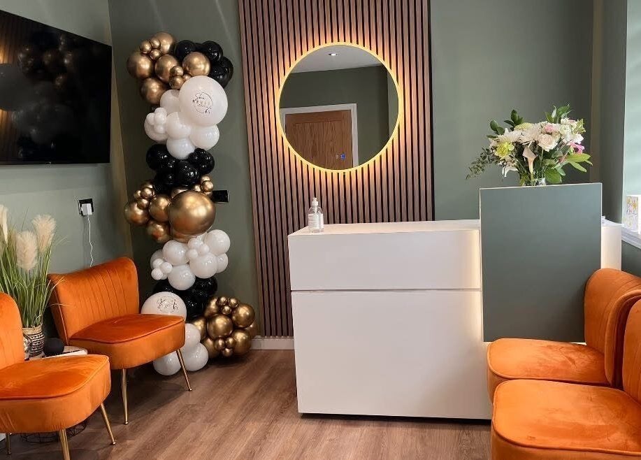 Elegant reception with orange chairs and balloons at Natalie Mcintyre Aesthetics, Bishopbriggs, Scotland, GB.