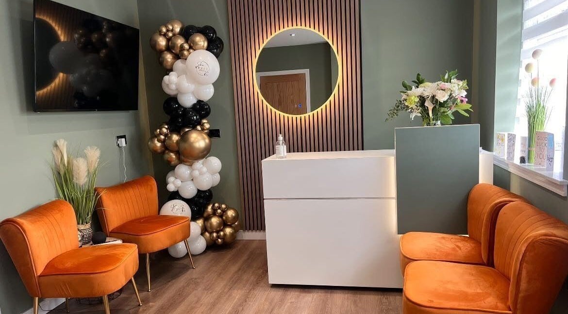 Elegant reception with orange chairs and balloons at Natalie Mcintyre Aesthetics, Bishopbriggs, Scotland, GB.