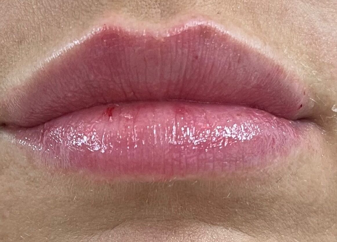 Close-up of glossy lips at Natalie Mcintyre Aesthetics, Bishopbriggs, Scotland, GB showcasing beauty treatment.