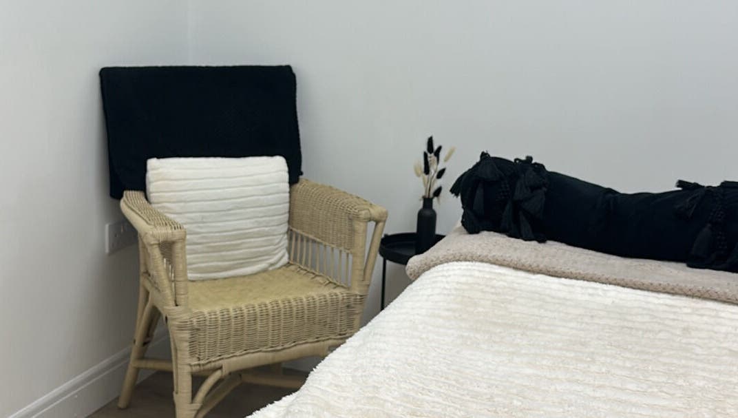 Relax in the elegant treatment room at Paint By Tate, Newport, Wales, GB. Soft linens and chair add comfort.