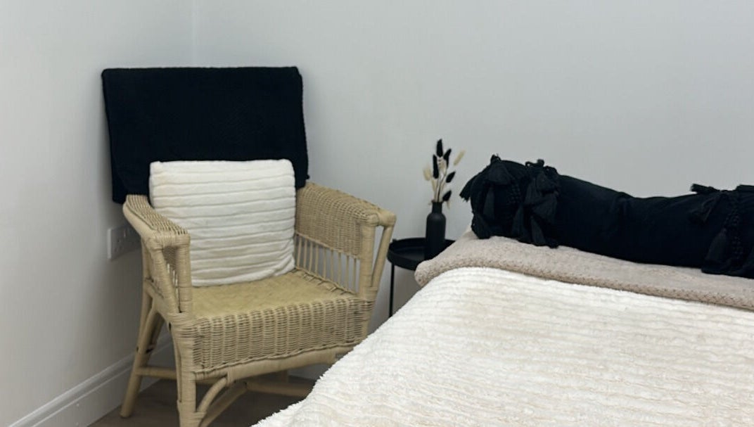 Relax in the elegant treatment room at Paint By Tate, Newport, Wales, GB. Soft linens and chair add comfort.