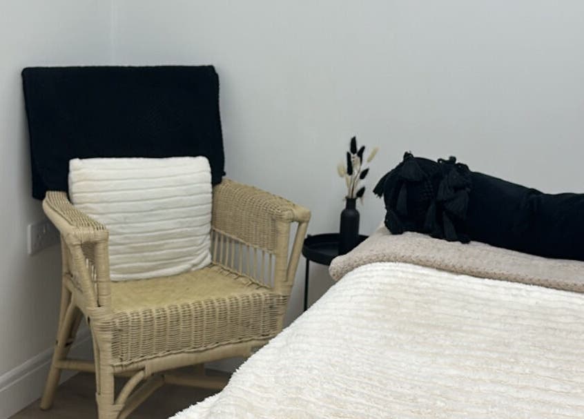 Relax in the elegant treatment room at Paint By Tate, Newport, Wales, GB. Soft linens and chair add comfort.