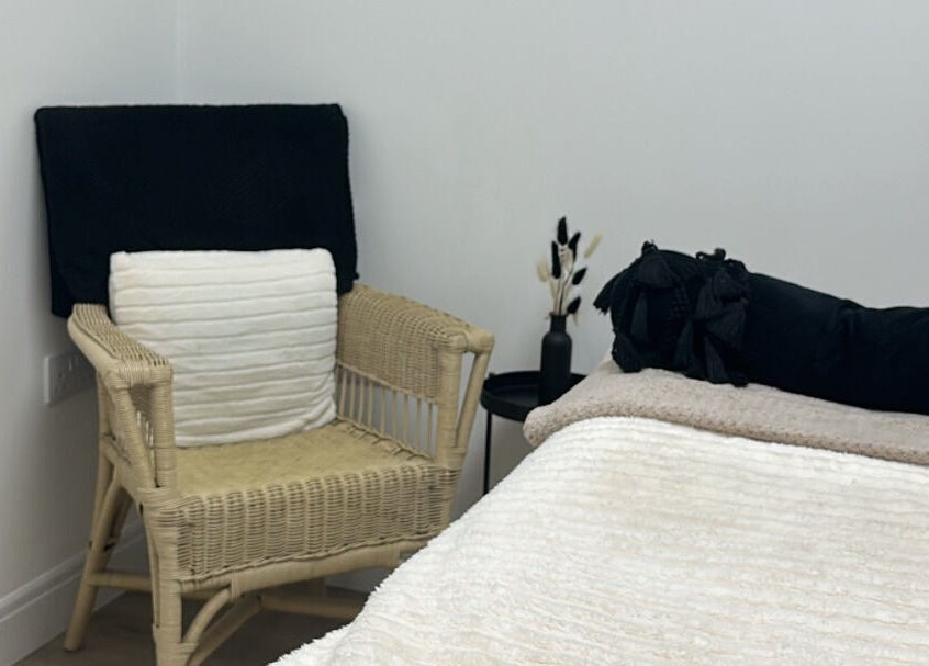 Relax in the elegant treatment room at Paint By Tate, Newport, Wales, GB. Soft linens and chair add comfort.