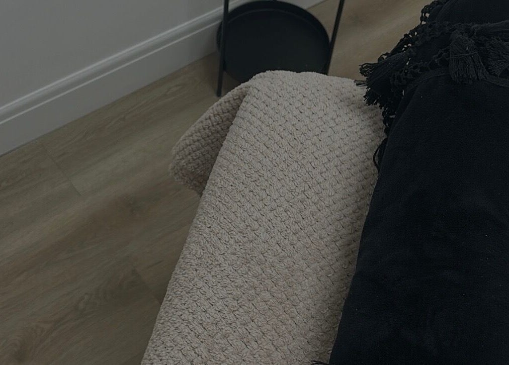 Relaxing therapy bed setup at Paint By Tate, Newport, Wales, GB, featuring a plush black bolster and soft blanket.