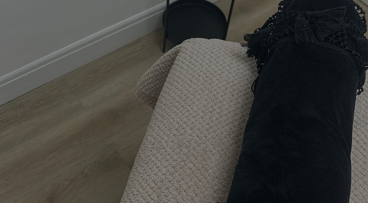 Relaxing therapy bed setup at Paint By Tate, Newport, Wales, GB, featuring a plush black bolster and soft blanket.