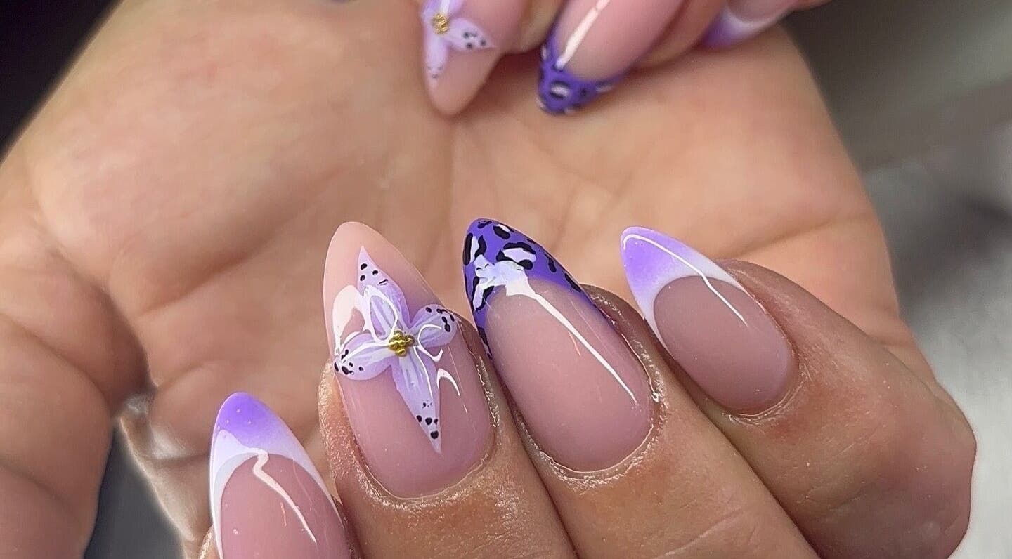 Stylish floral nail art in purple hues at BeauTai Esthetics, Pickering, Ontario, CA. Perfect for chic manicure lovers.