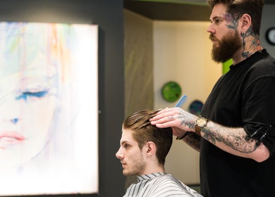 A stylist at Hairsoda Private Studio (Yaletown) in Vancouver, BC, CA crafting a modern men's hairstyle.