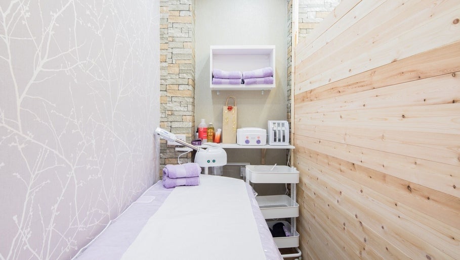 Serene treatment room at Starlight Hair and Beauty in London, England, GB, with soft lavender towels.