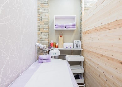 Serene treatment room at Starlight Hair and Beauty in London, England, GB, with soft lavender towels.