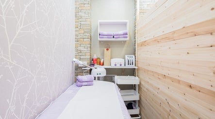 Serene treatment room at Starlight Hair and Beauty in London, England, GB, with soft lavender towels.