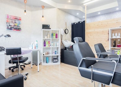 Chic interior of Starlight Hair and Beauty in London, England, GB featuring salon chairs and nail polish display.