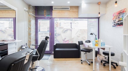 Cozy interior of Starlight Hair and Beauty in London, England, GB with modern styling chairs and nail polish wall.