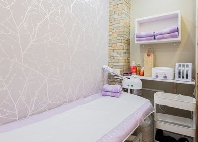Relaxing treatment room at Starlight Hair and Beauty, London, England, GB featuring soft decor and amenities.