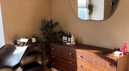 Elegant Caitlin Marie Makeup studio in Arklow, County Wicklow, IE with a stylish wooden dresser and mirror.