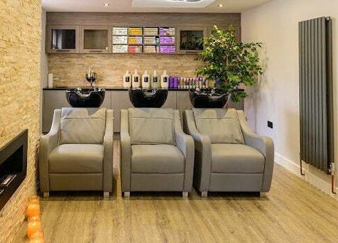Luxurious wash area at Marcia & Co in Freckleton, England, GB featuring modern chairs and sleek cabinetry.