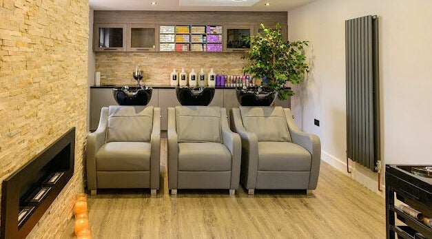 Luxurious wash area at Marcia & Co in Freckleton, England, GB featuring modern chairs and sleek cabinetry.