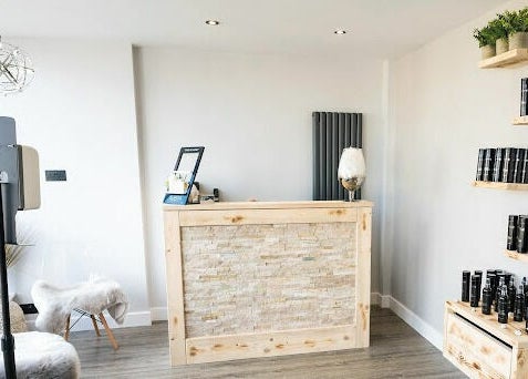 Elegant reception area at Marcia & Co in Freckleton, England featuring natural wood accents and product displays.