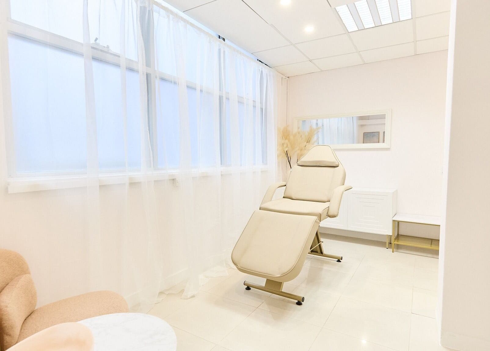 Relaxing treatment room at Arte Aesthetics, Sydney, New South Wales, AU with a plush recliner and soft decor.