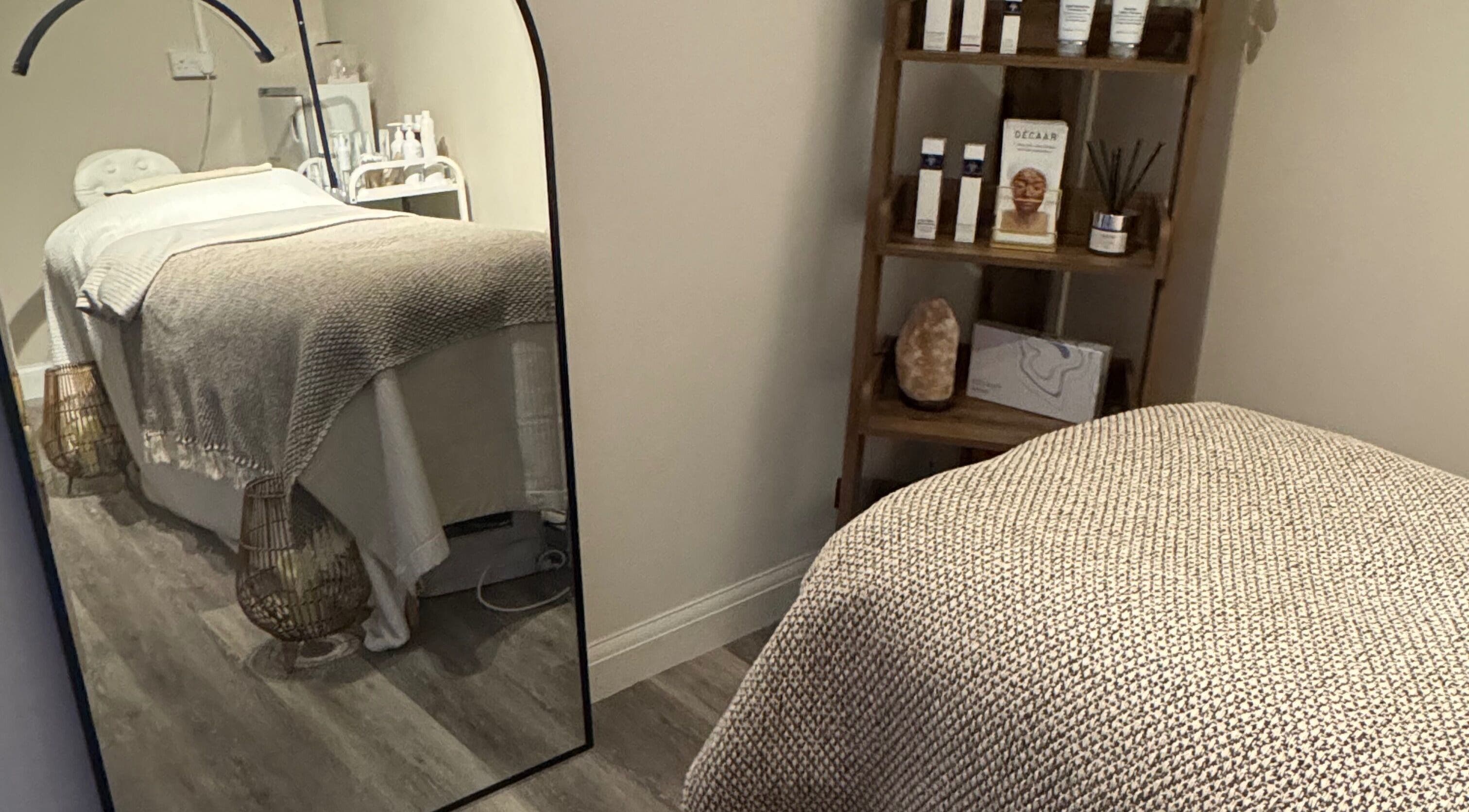 Cozy treatment room at Radiant Skin Clinic in Peterborough, England, GB, with spa bed and skincare products.