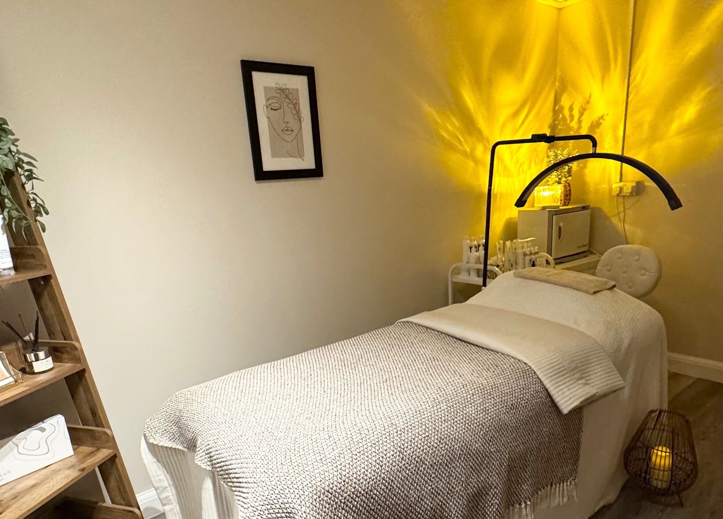 Cozy treatment room at Radiant Skin Clinic, Peterborough, England, GB with soft lighting and beauty products.