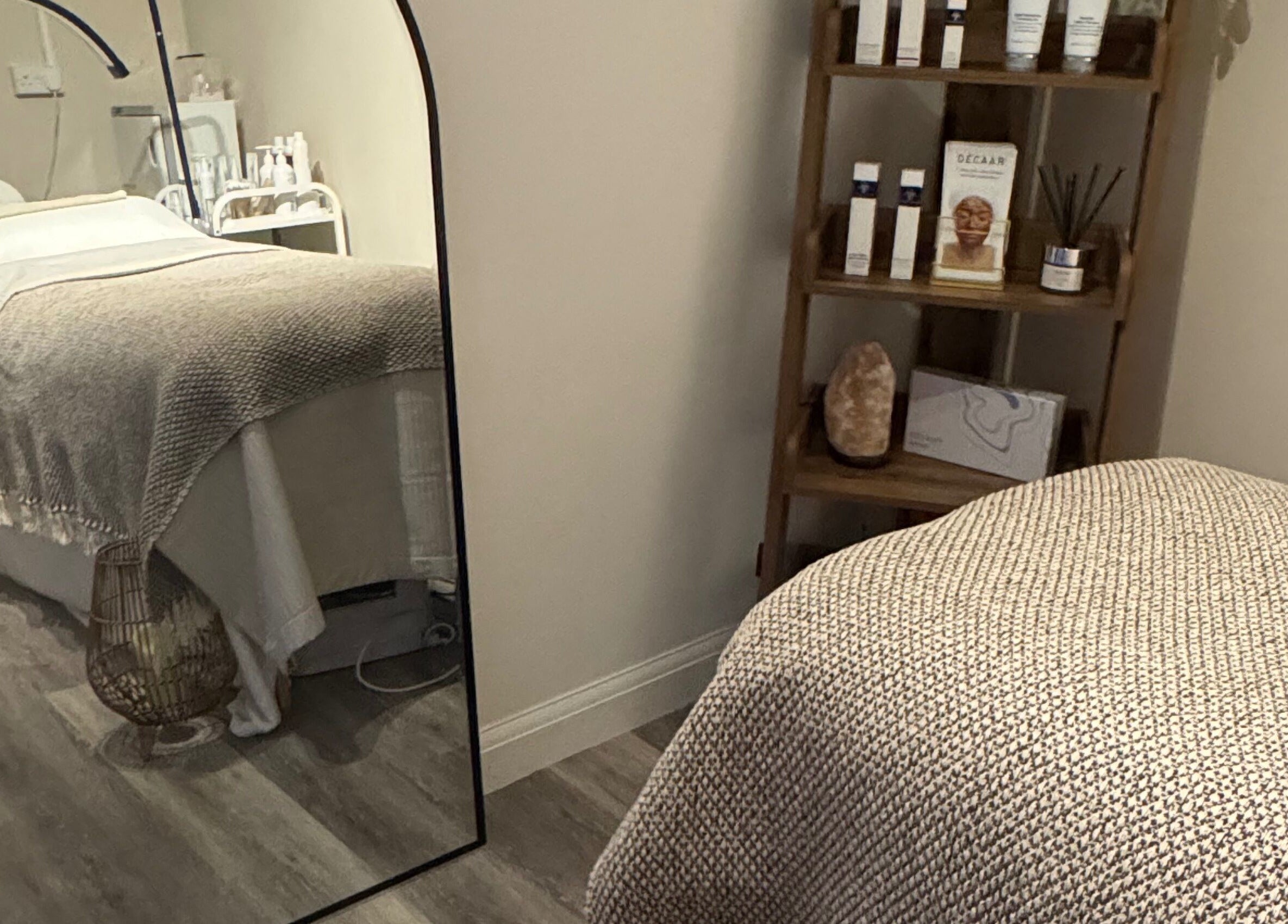 Cozy treatment room at Radiant Skin Clinic in Peterborough, England, GB with a comfy bed and skincare products.
