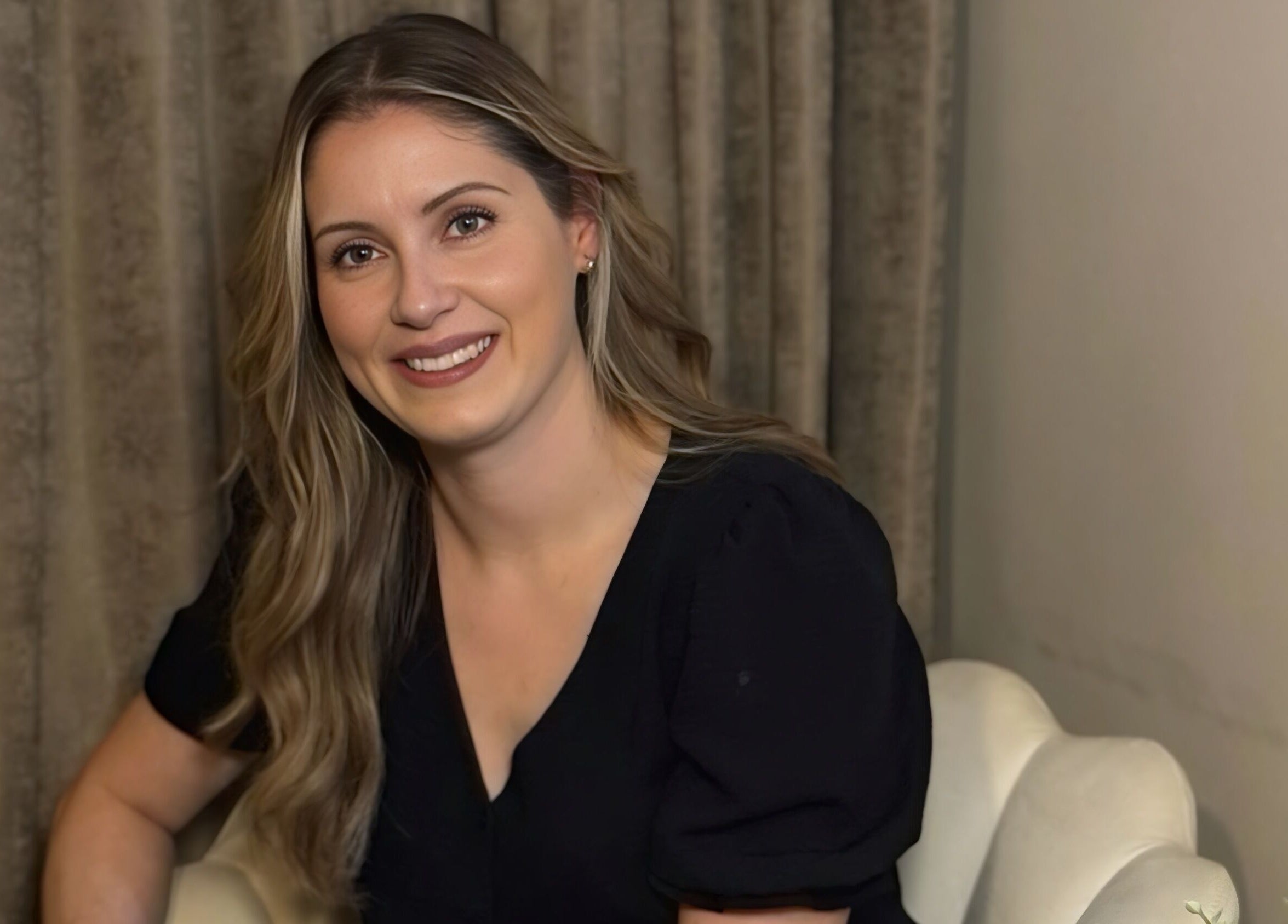 A smiling person at Radiant Skin Clinic, Peterborough, England, GB, highlighting serene ambiance.