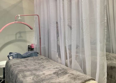 Cozy treatment room at Beauty Bar n Makeup, Lash n Brows in Auckland, Auckland, NZ with soft lighting and plush bed.