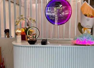 Elegant reception at Beauty Bar n Makeup, Lash n Brows, Auckland, NZ with modern decor and colorful sign.