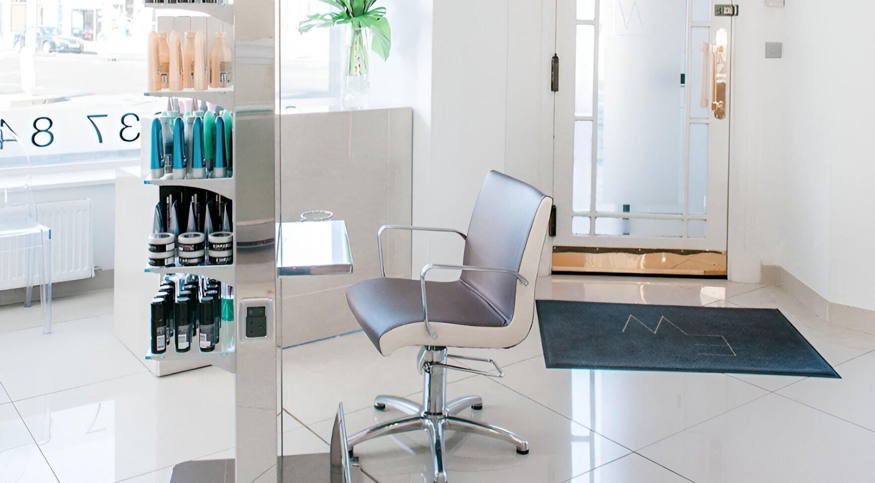 Modern salon chair in Steph Gillon Hair, Edinburgh, Scotland, GB with sleek flooring and product display.