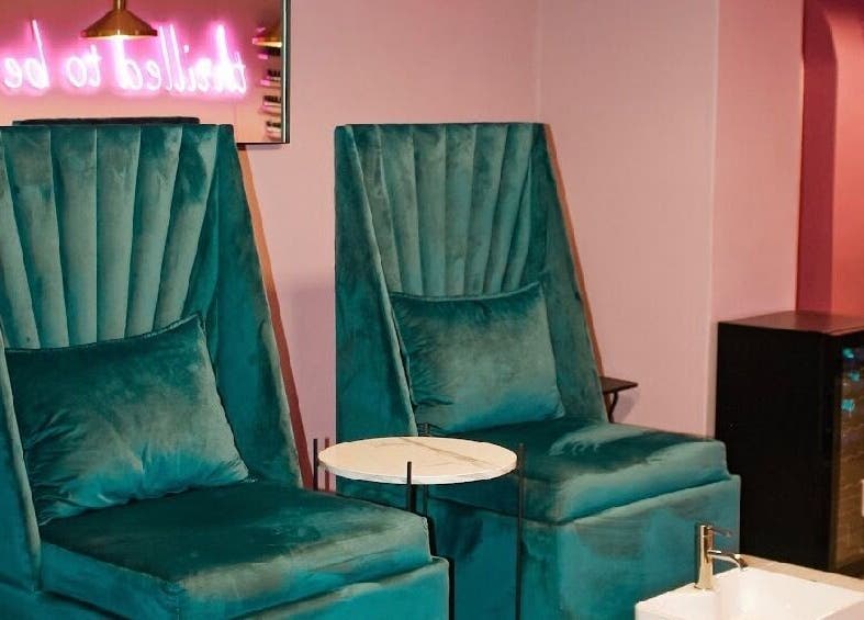 Luxurious velvet chairs at Ellainc Beauty Nail Bar, Cape Town, Western Cape, ZA showcasing a chic pedicure setup.