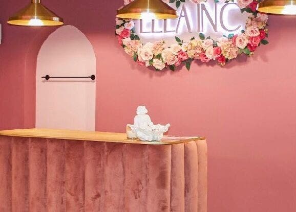 Elegant pink reception at Ellainc Beauty Nail Bar, Cape Town, Western Cape, ZA with floral accents and modern lighting.