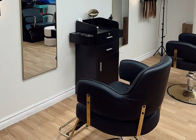 Stylish salon setup at Styled by Krystina, Dollard-des-ormeaux, Québec, CA with modern black chairs.