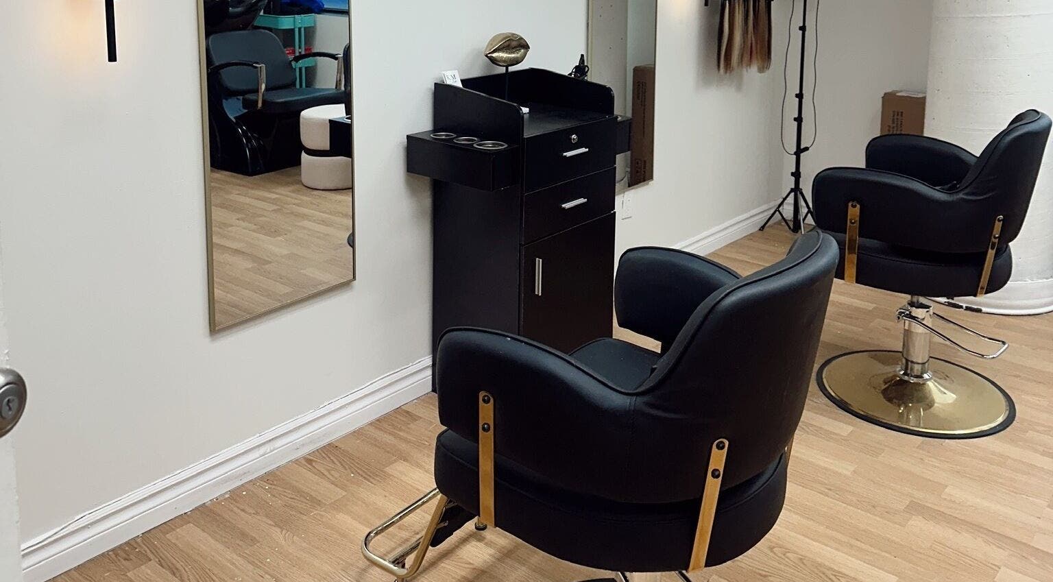 Stylish salon setup at Styled by Krystina, Dollard-des-ormeaux, Québec, CA with modern black chairs.