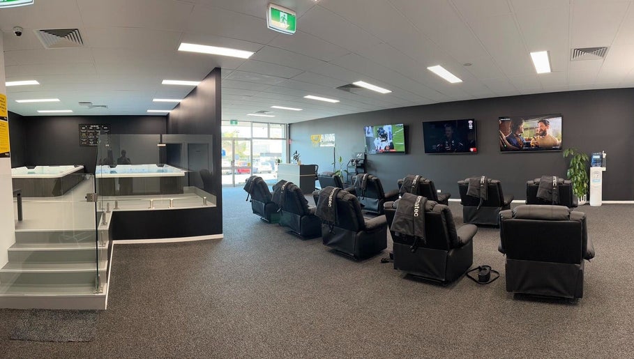 Modern wellness area at Ark Sports Recovery, Belmont, Victoria, AU with massage chairs and therapy pools.