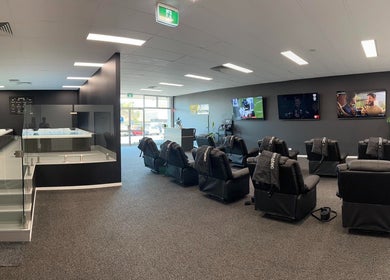 Modern wellness area at Ark Sports Recovery, Belmont, Victoria, AU with massage chairs and therapy pools.