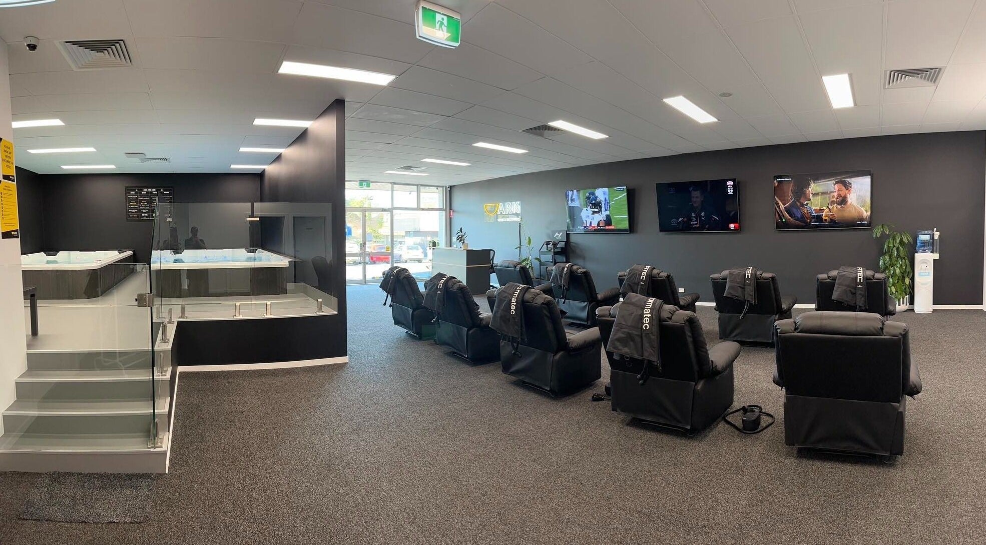 Modern wellness area at Ark Sports Recovery, Belmont, Victoria, AU with massage chairs and therapy pools.