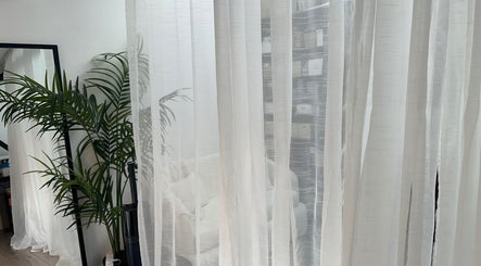 Elegant interior with white curtains and lush plants at PRF London | JazLooks, Wembley, England, GB.
