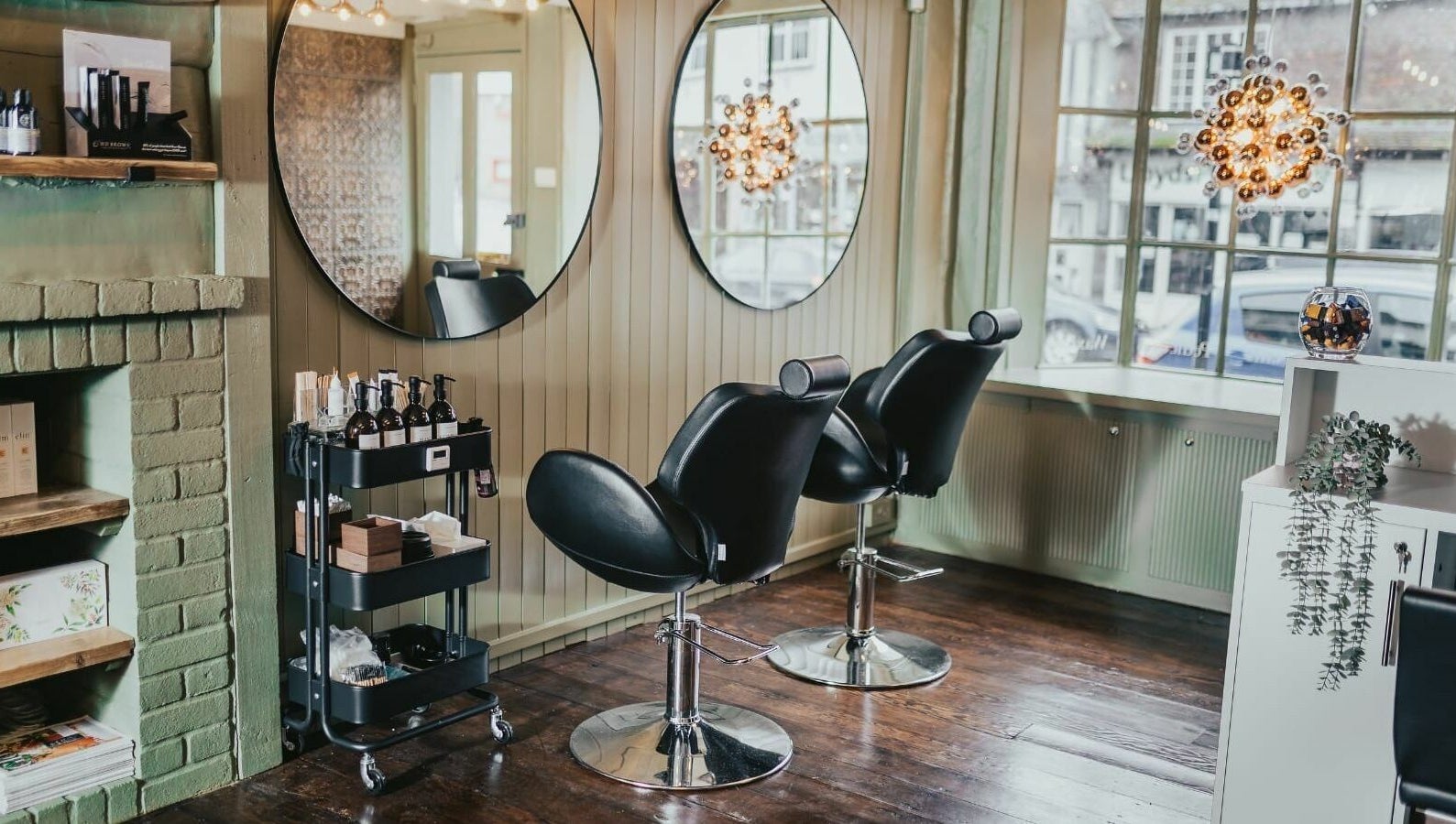 Elegant salon chairs at The Foundry, Cranbrook, England, GB, with stylish mirrors and ambient lighting.